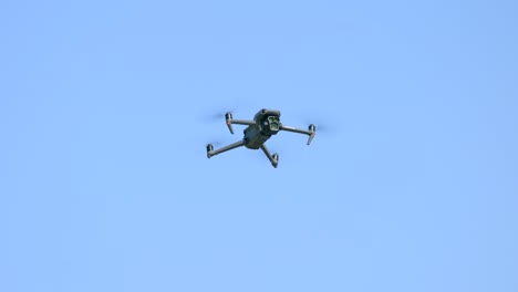 drone hovering against clear blue sky