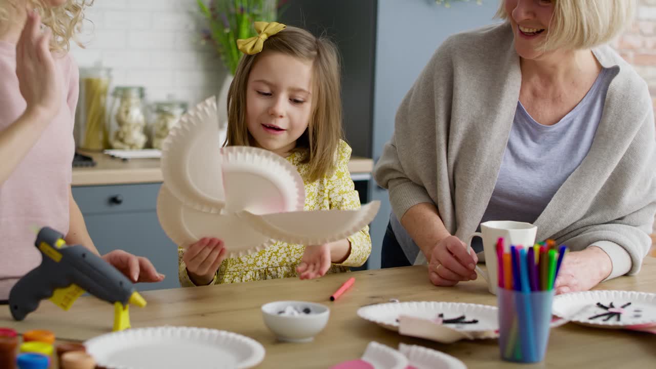 Handheld video of little girl makes an Easter bunny