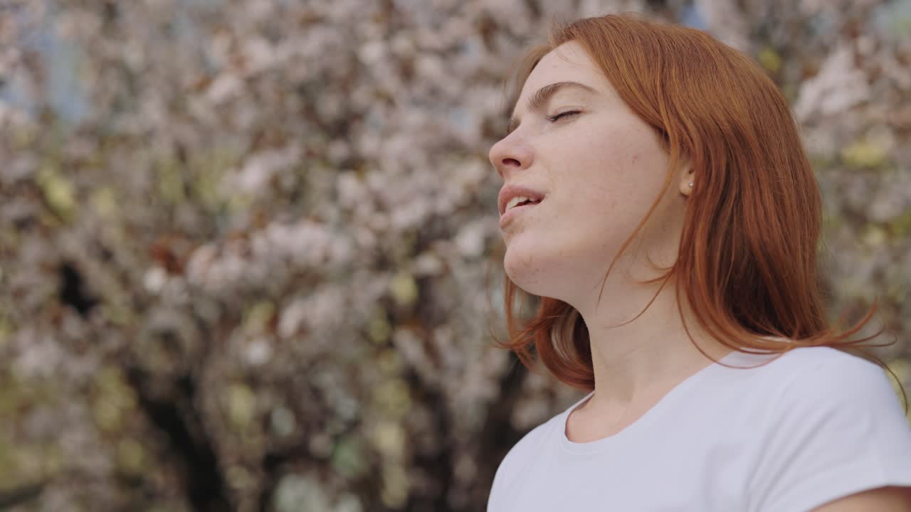 Woman Wearing Mask in Blooming Spring Trees