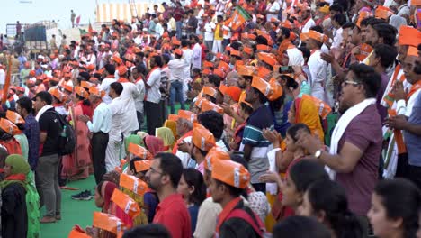 masses wearing namo merchandise at an event to support bjp candidate and chief minister yogi adityanath lok sabha election campaign mega rally, assi ghat temple