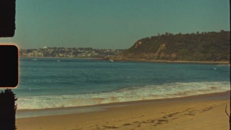 vintage coastal landscape with waves and distant city