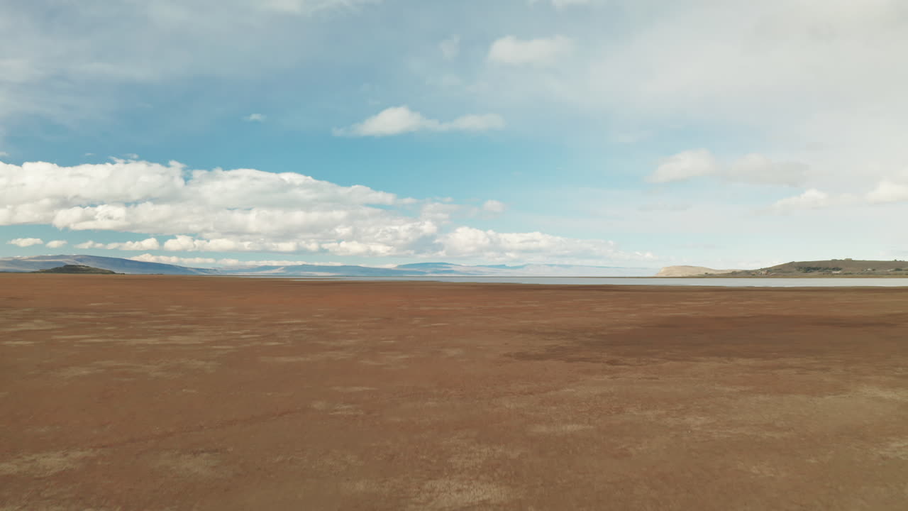Lone traveller Waking in the Patagonian Steppe, Argentina.
Aerial View of Adventurous Explorer Alone in the Wilderness.
Panoramic View of Brown Ground and Cloudy Blue Sky.