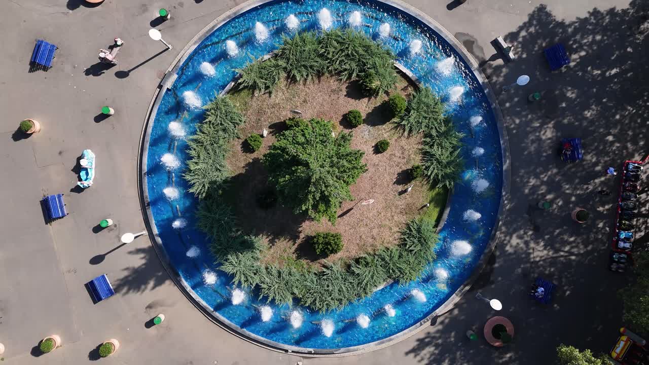 Aerial View of a Park with a Circular Fountain