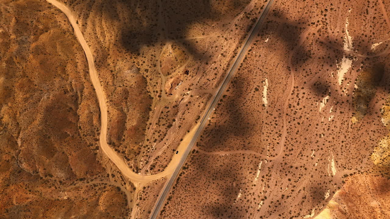 Dry hot area of Mojave desert, California, USA. Shadows of clouds floating by the landscape. Top view.