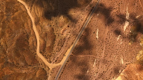 dry hot area of mojave desert, california, usa. shadows of clouds floating by the landscape. top view.