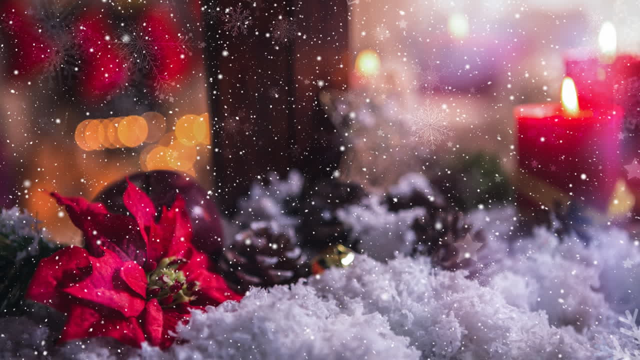 Candles and christmas decoration outside a window combined with falling snow