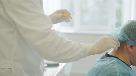 a doctor administering botulinum injections to a patient as a treatment for bruxism and spasticity. the clinical setting emphasizes professionalism and medical expertise