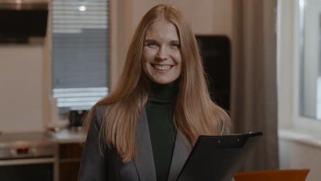 real estate agent posing with clipboard