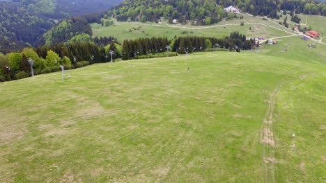 mountain bike rider cycling down a beautiful, lush green hill at the malino brdo bike park in liptov, slovakia