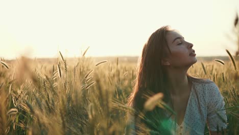 woman in a wheat field at sunset