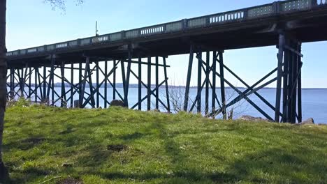 aerial drone park to bridge beams on slough looking to bay