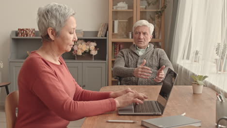 elderly couple communicating using a laptop