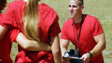 trainer instructing kids in the boot camp