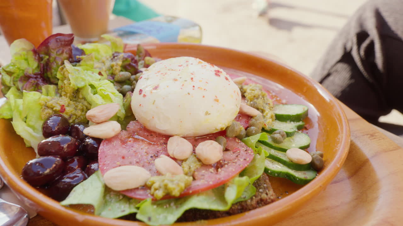 A caf&eacute;-served salad featuring lettuce, mozzarella, and nuts on a plate, offering a nutritious and tasty meal option