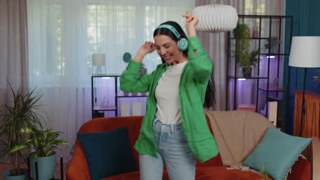 Chica-Feliz-Y-Relajada-Con-Auriculares-Inalámbricos-Bailando-Escuchando-Música-Rock-N-Roll-Favorita-En-La-Habitación-De-Casa