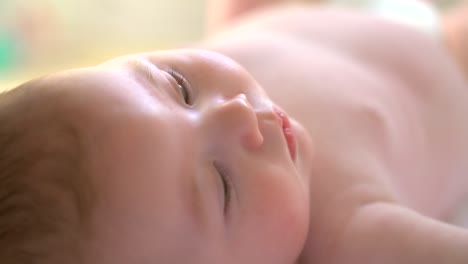 baby lying on back in sunlight