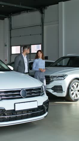 customer looking at new cars in a dealership