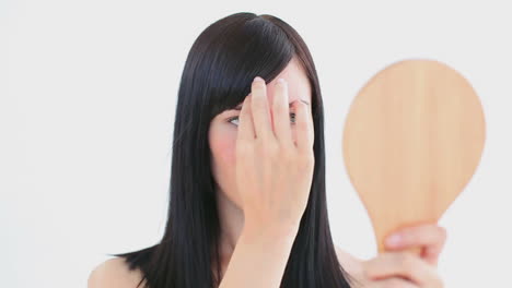 smiling woman brushing her fringe