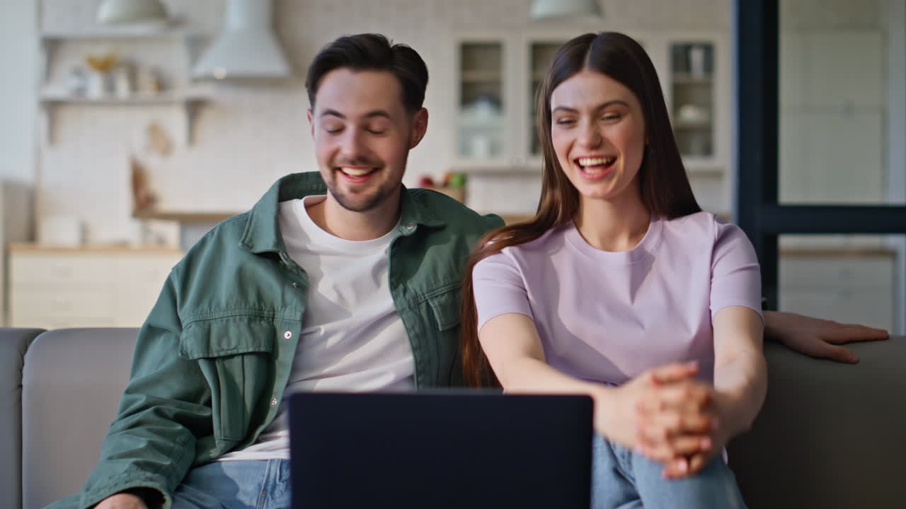 Spouses talking online meeting by laptop at home closeup. Couple video calling