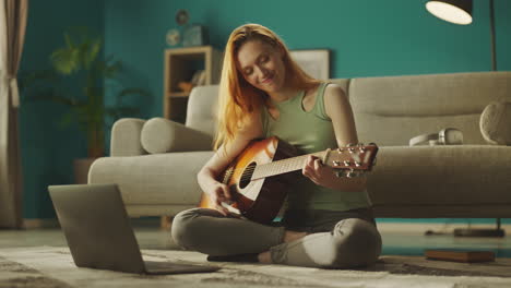 woman learning guitar in online class