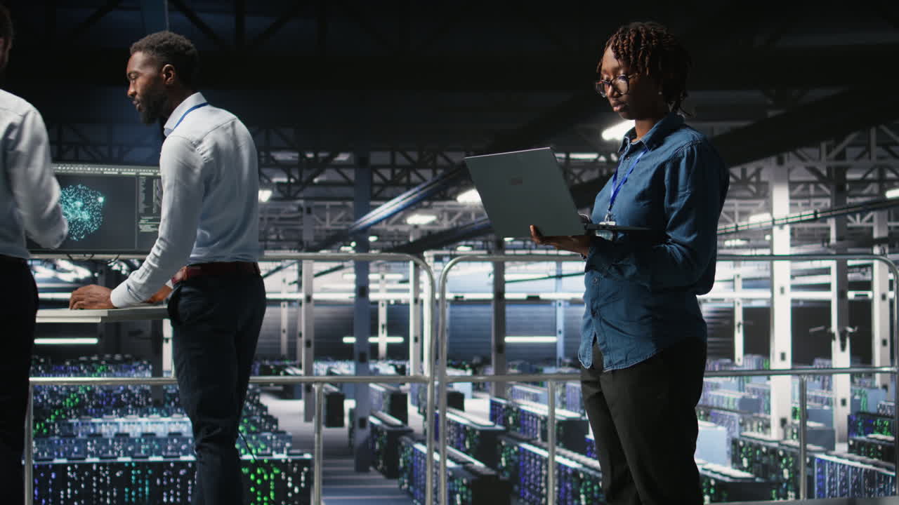 Data center system administrators doing maintenance tasks on laptop