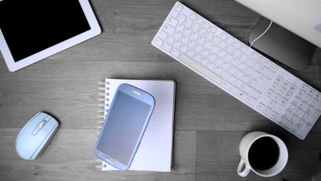 smartphone phone falling on office desk in black and white