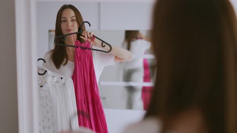 woman trying on dresses in a fitting room