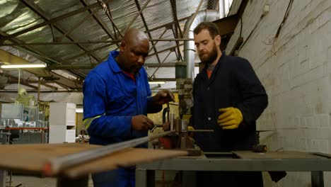 two metalsmiths working in workshop 4k