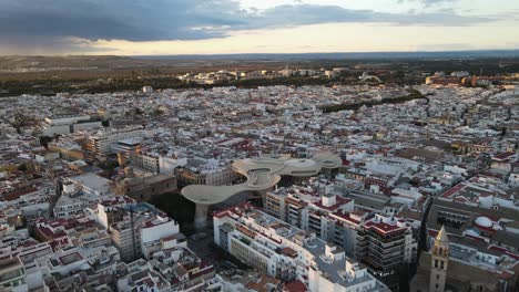 aerial drone shot of seville, the capital city of spain's andalusia region. also seen here is a public art structure known as "las setas"