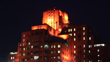 spotlights have been placed on different wings of a building to create a unique effect