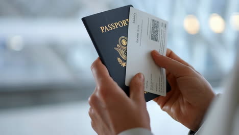 A person holding an American passport and an official document