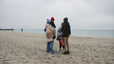 friends talking on a winter beach