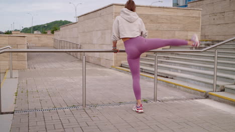 woman stretching on outdoor stairs