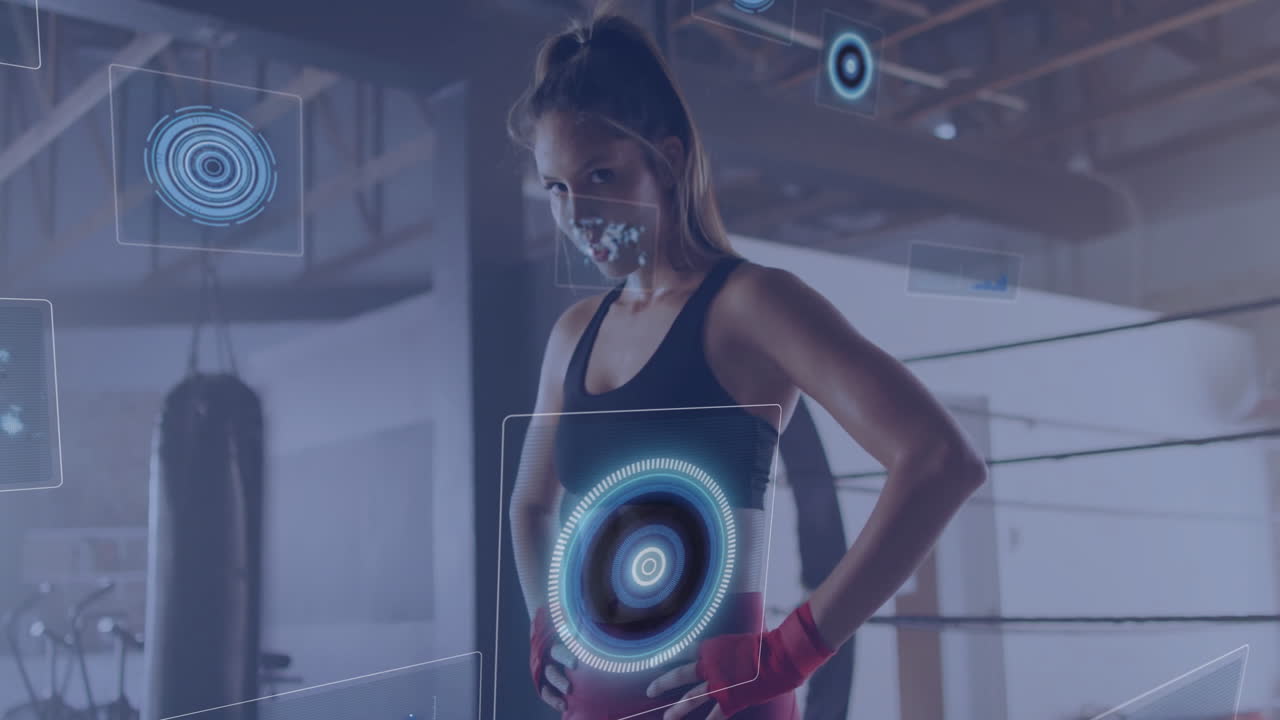 female boxer standing by punching bag, wearing red hand wraps, showcasing holographic fitness HUD