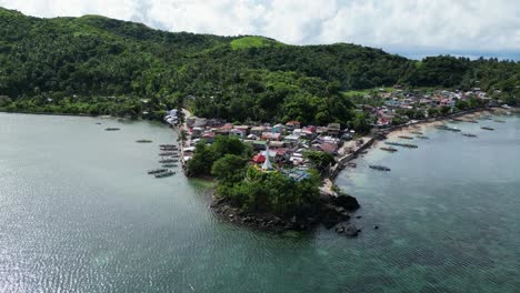 Small-remote-fisher-village,-Philippines-island,-aerial-backward-establisher