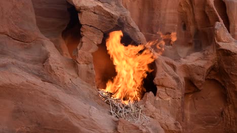 large fire burning in a rocky cavity, wadi rum desert