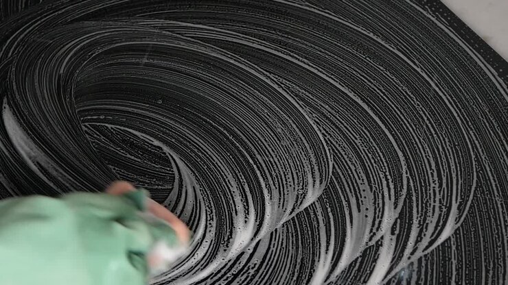 Cleaning a surface with soap and a glove