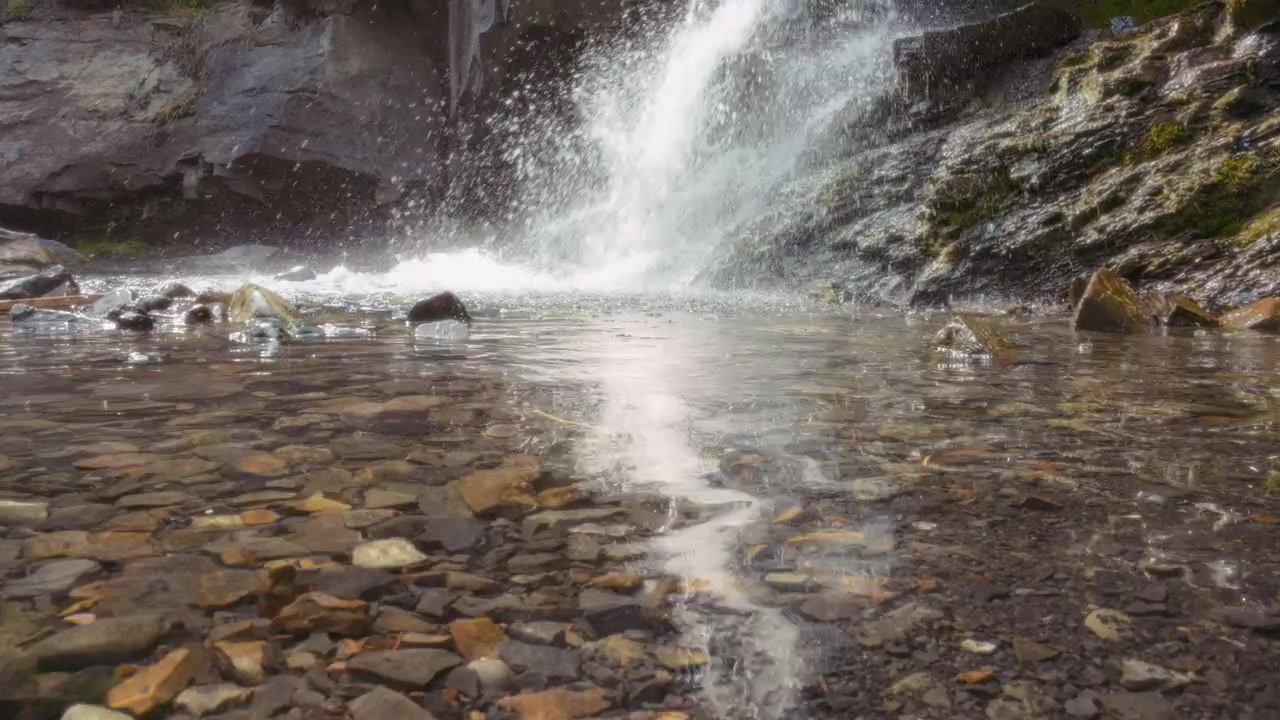 Small waterfall crashing onto the rocks in the river