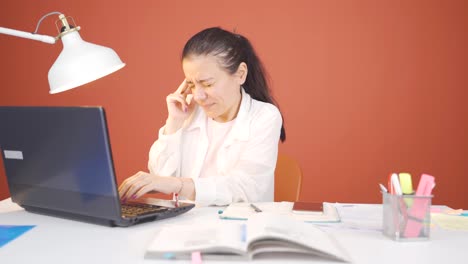 woman working on laptop has a headache.