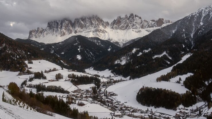 Post card first snow autumn winter fresh snowfall cinematic Timelapse sunset clouds Val di Funes village Dolomites northern Italy St Santa Magdalena Maddalena Johann Chapel Church Italia Bozen Bolzano