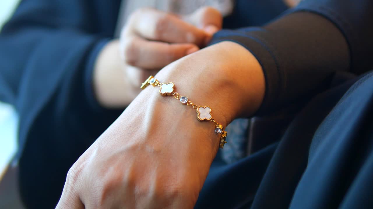 Gold Bracelet on Woman's Wrist