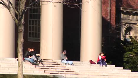 Students-Sit-On-The-Steps-Of-The-Church-At-Harvard-University