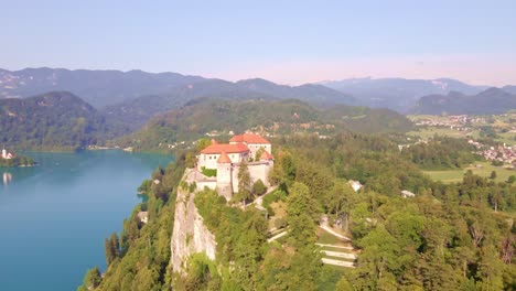 point of interest aerial showcasing bled castle high above lake bled and the surrounding julian alps landscape in slovenia