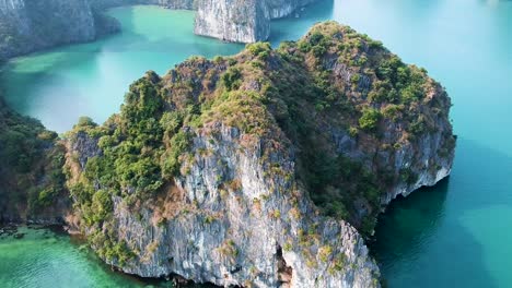 Aerial-drone-shot-over-Ha-Long-Bay,-blue-sea-and-limestone-islands-of-Lan-ha-bay