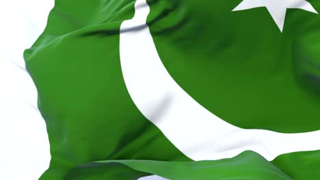 pakistan flag waving at wind with blue sky in slow, loop