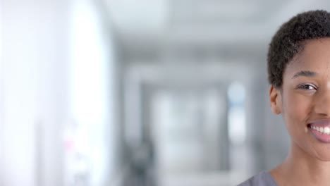 portrait of happy african american female doctor smiling, copy space, slow motion