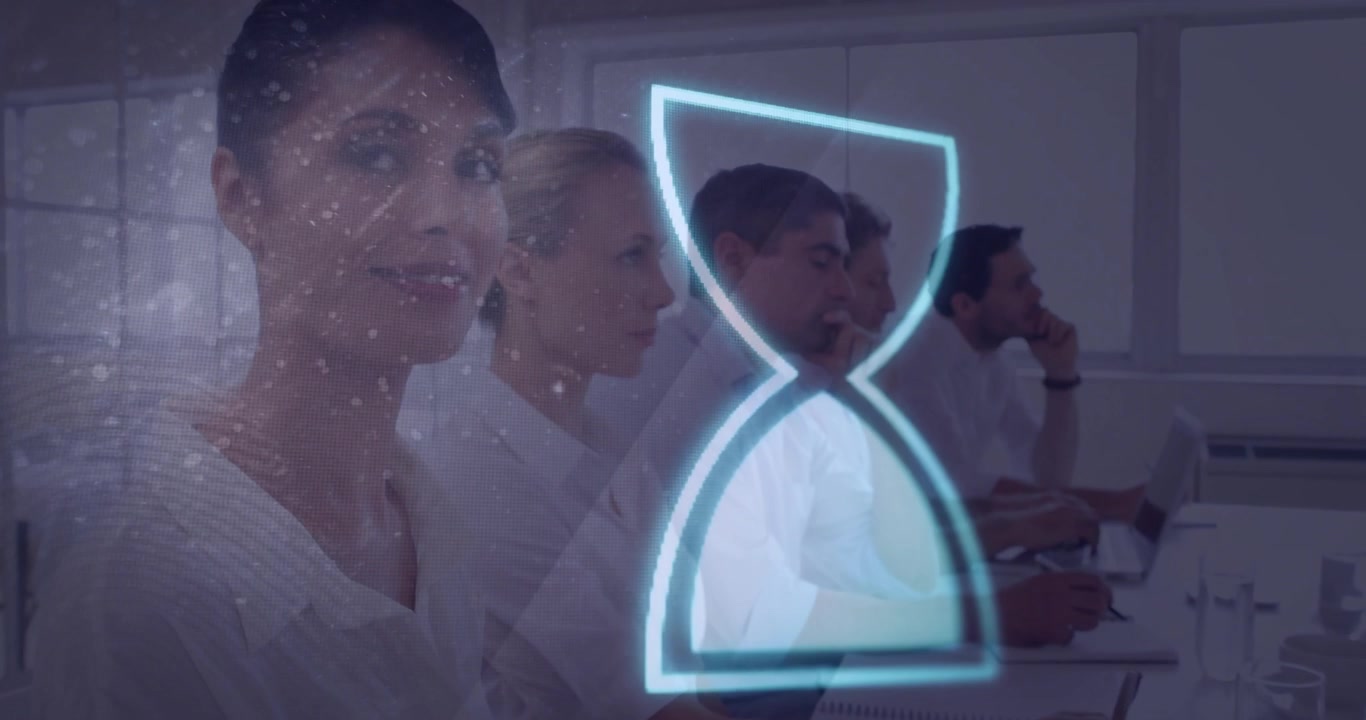 Business team sitting at table with laptops, glowing hourglass icon highlighting time management