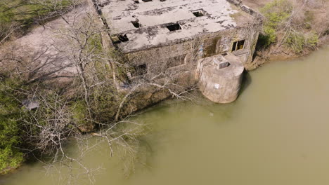 establishing shot of a weathered river pump station at white river, arkansas