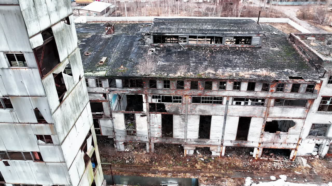 Deserted and solitary industrial zone of a plant destroyed with time. Abandoned territory dangerous for visiting. View from above.