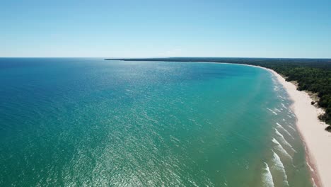 Wunderschöne-Drohnenaufnahme-Mit-Schwenk-Nach-Rechts-Auf-Das-Farbenfrohe-Wasser-Des-Michigansees